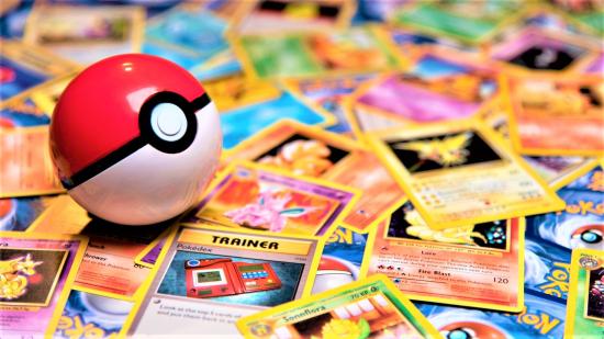 photo of a pokeball on top of hundreds of pokemon cards