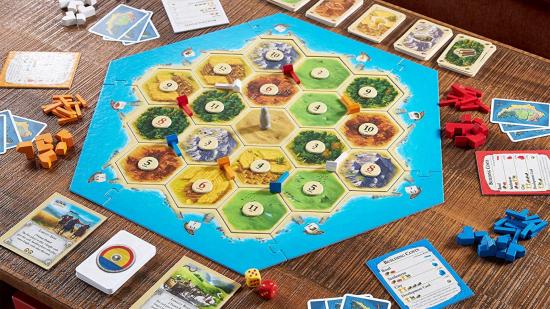 How to play Catan - Official Catan marketing photo showing a six player game fully set up with board, cards, and pieces