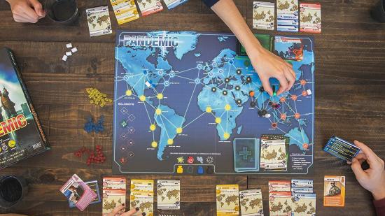 Best board games for Christmas Pandemic being played on a wooden table