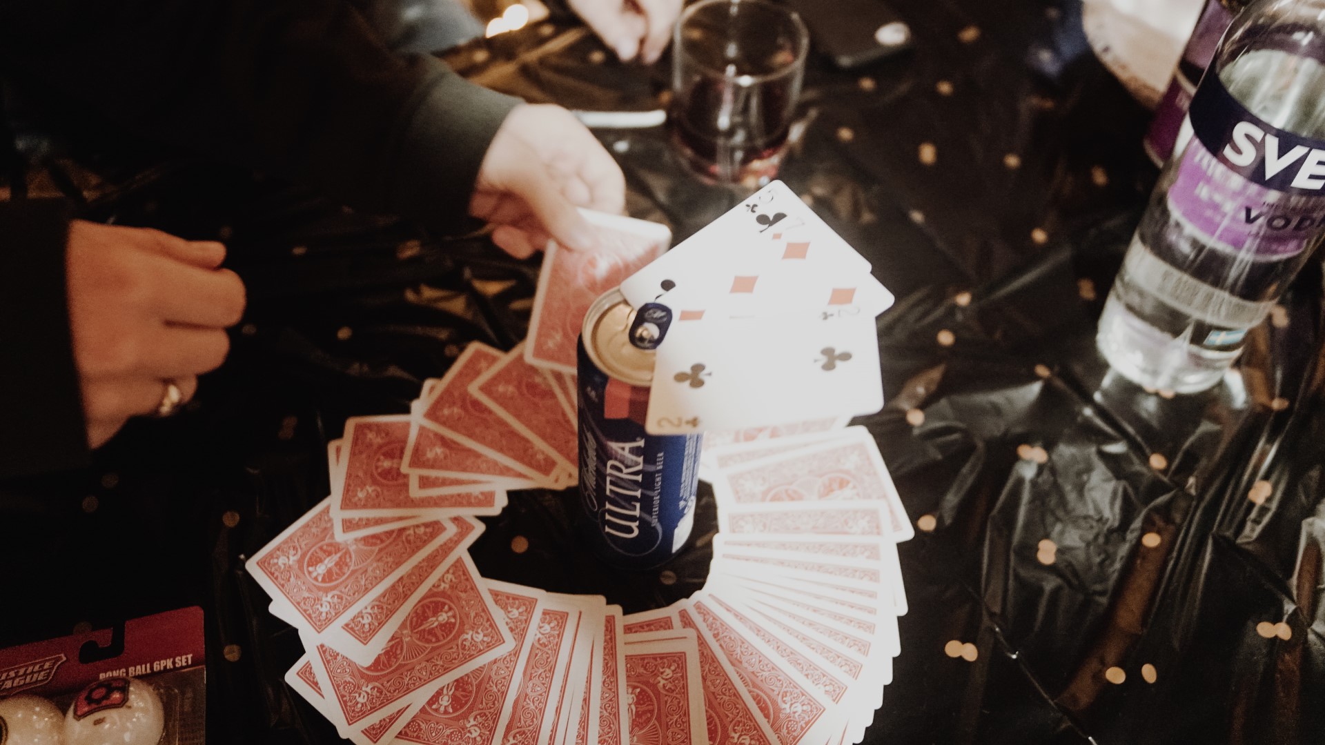 Drinking card games a game of King's cup being played, credit to Unsplash Taylor Friehl