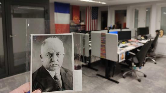 Hearts of Iron 4 update to French Communist focus tree leaders - Paradox photo showing developer office, with French flag and photo of Rene Nicod
