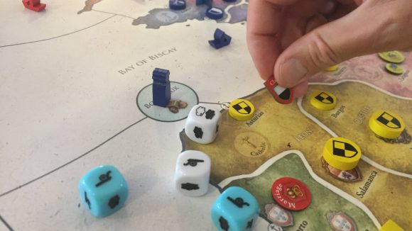 Europa Universalis board game release date a hand placing a token on the board
