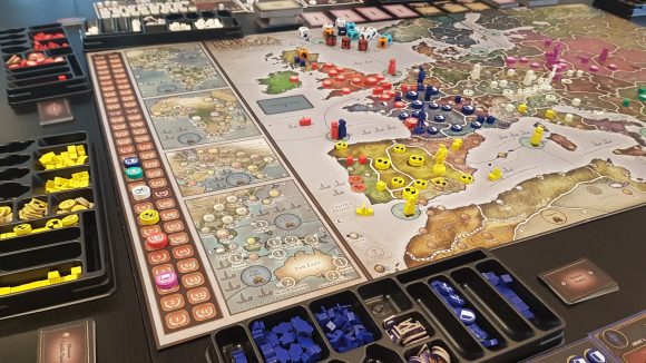 Europa Universalis: The Price of Power expansions a map of Western Europe with tokens and cards laid out around it