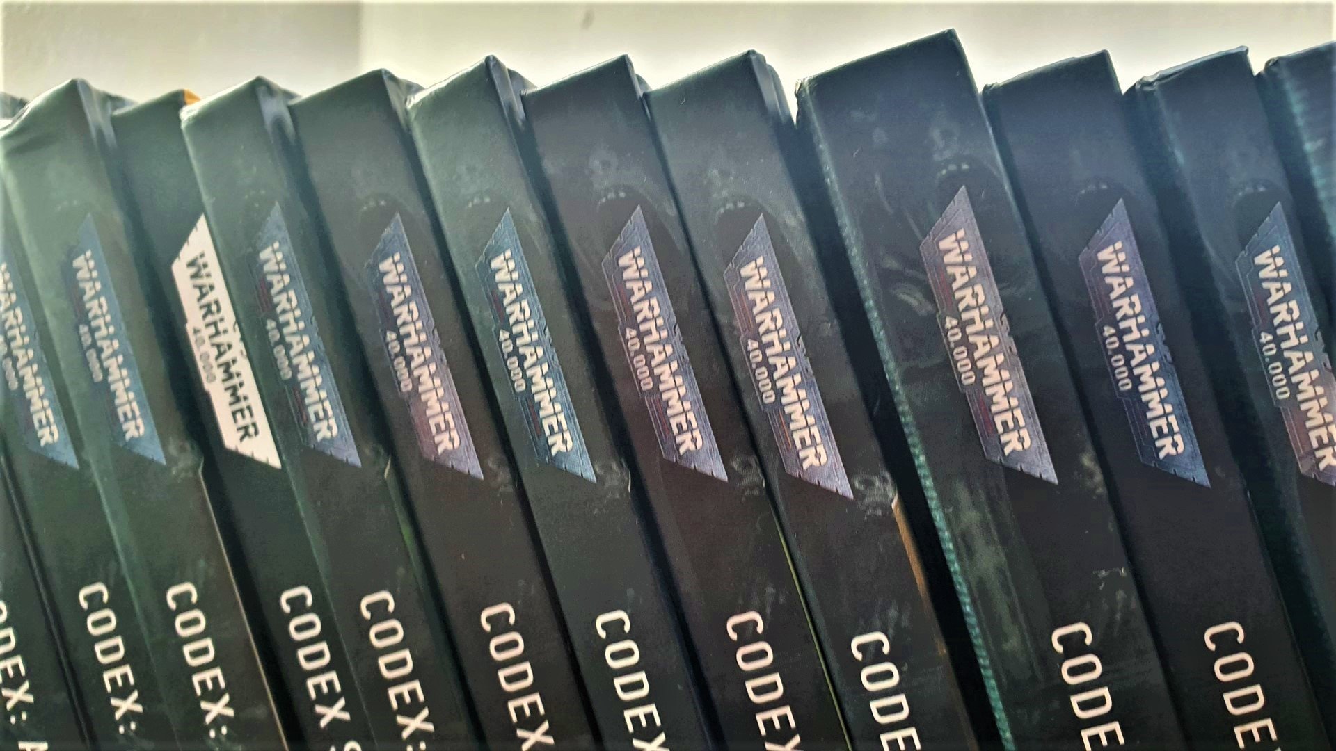 Warhammer 40k codex release date guide - author photo showing titles and spines of Warhammer 40k codex books
