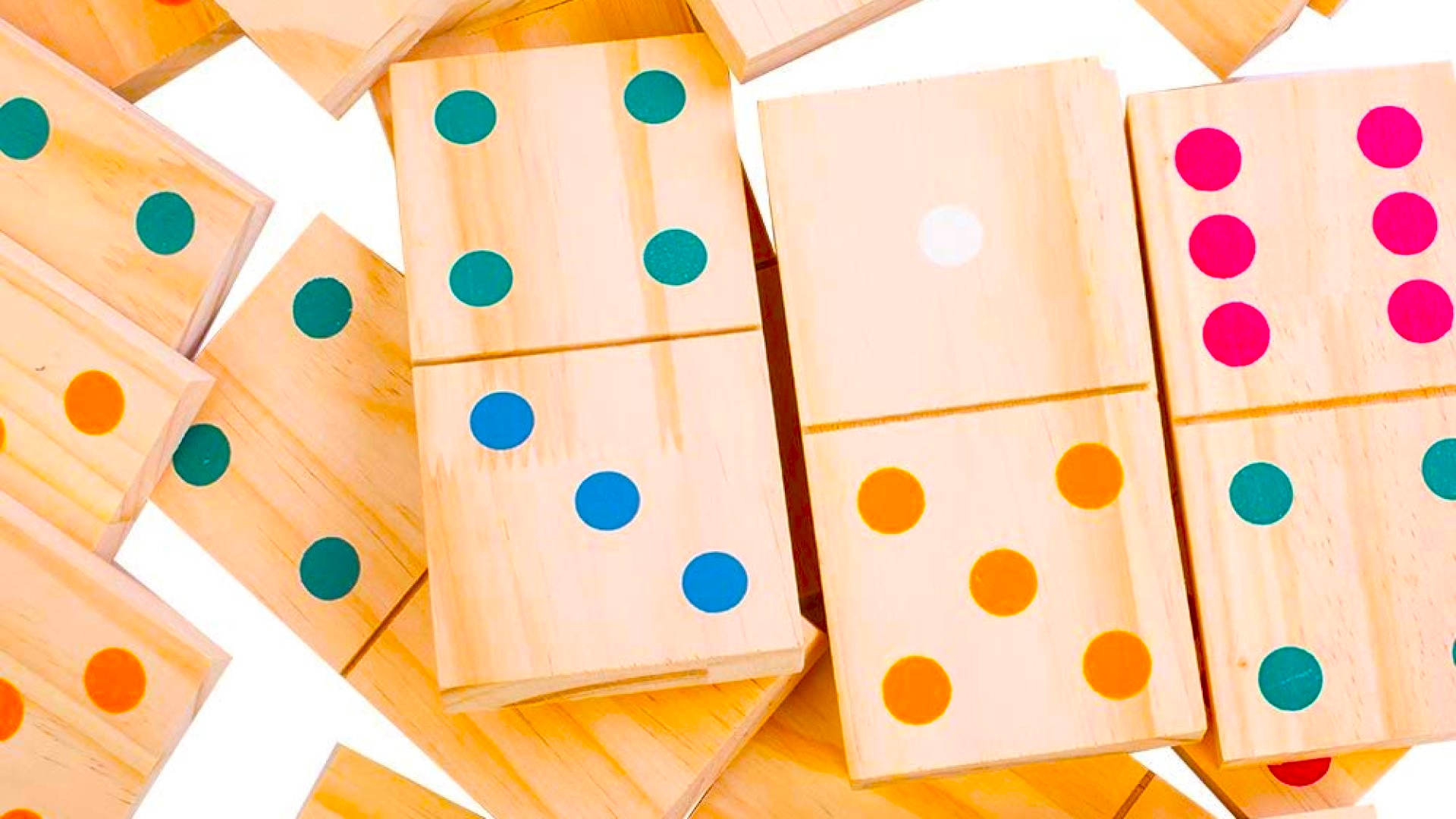 How to play dominoes domino pile coloured dots closeup photo