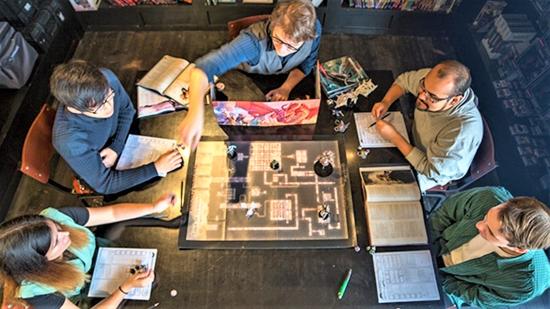 DnD maps - the best D&D map makers - author photo showing D&D players around a tabletop game or battle map