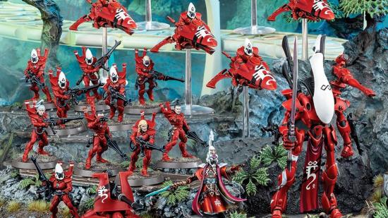 Warhammer 40K Eldar models from the new Eldar combat patrol, painted red and arranged amidst tropical terrain.