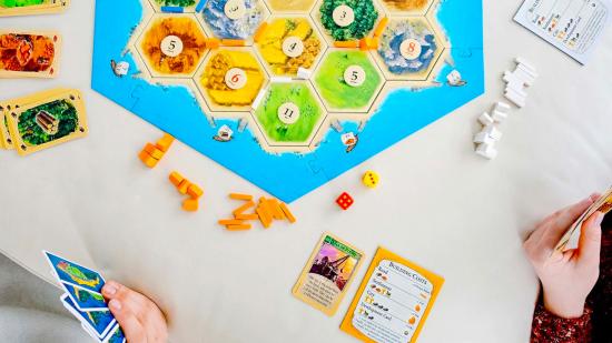 Amazon Prime Day Board Game deals - Catan sales photo showing the Catan board, hexes, cards, and pieces