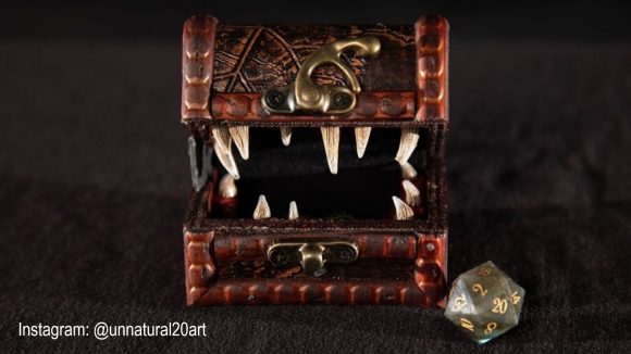 DND dice DIY torture device - a open chest with teeth, and a 20-sided die next to it