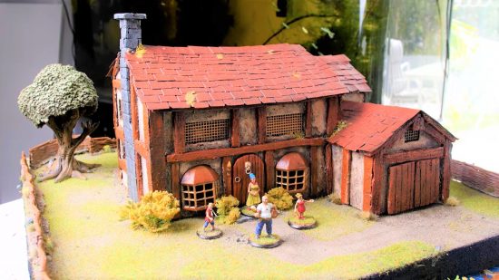 DnD simpsons - a miniature recreation of the simpsons' house redesigned in fantasy style, with miniatures of the simpsons family.