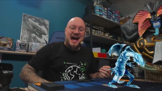 Yugioh Trading Card Game - a streamer playing yugioh with a hologram blue-eyes white dragon on the board.