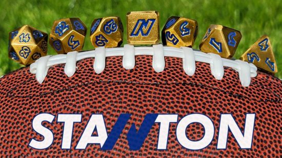 DnD NFL Johnny Stanton golden dice sat on top of a American Football