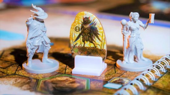 Gloomhaven PAX game reveal - two plastic minis and a cardboard creature from Gloomhaven: Jaws of the Lion