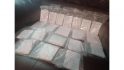 MTG decks made in prison - basic paper versions of MTG cards in plastic baggies laid out on a sofa