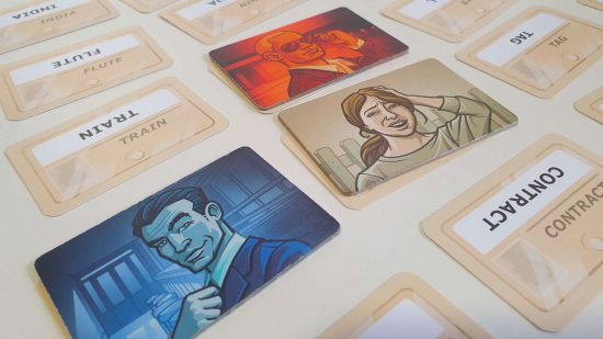 Codenames - photograph of a game in progress, a grid of word cards, with coloured tiles placed over some words to indicate they've been picked by a player