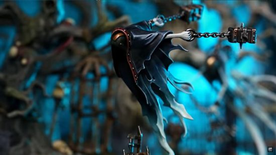 Nighthaunt army guide - photo by Games Workshop of a model of a Chainghast, a swooping ghost with a mask covering its face,whirling two heavy metal lumps on chains