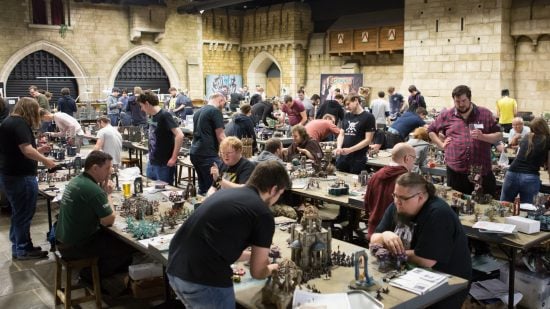 What is Warhammer 40k - gamers play tabletop wargames in a large hall