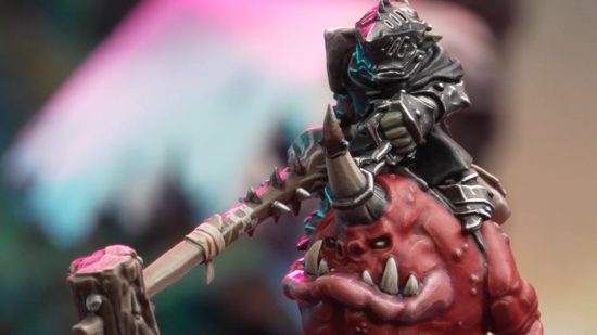 Warhammer Underworlds Grinkraks Looncourt review - close up photograph by Games Workshop of a painted model goblin knight wielding a lance and riding a squig, a round red monster that is mostly mouth