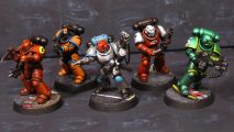 Warhammer 40k Space Marine Kill Team in F1 team colours - miniatures painted by redditor Plumpen, Space Marine models left to right in the colours of Ferrari, McLaren, Mercedes, Alfa Romeo, Aston Martin