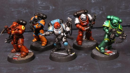 Warhammer 40k Space Marine Kill Team in F1 team colours - miniatures painted by redditor Plumpen, Space Marine models left to right in the colours of Ferrari, McLaren, Mercedes, Alfa Romeo, Aston Martin