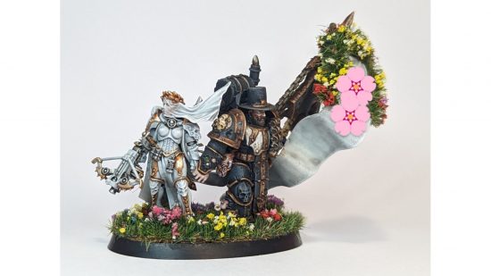 Warhammer 40k wedding cake topper - an inquisitor bride and death guard groom on a flower-covered base - side view