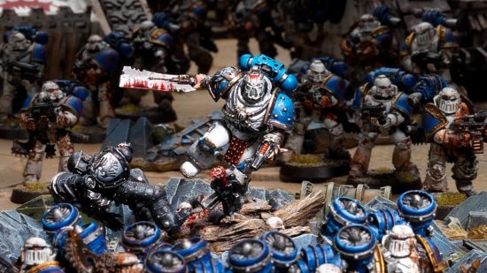 Warhammer 40k World Eaters - model by Games Workshop - Kharn, eighth Captain of the World Eaters, charges into melee wearing white and blue armour