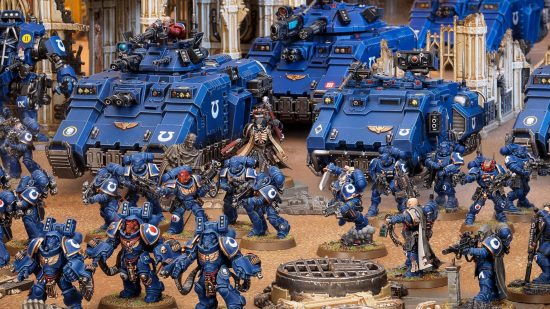 Warhammer supply drop - an army of blue-armoured Ultramarines Space Marines march ahead of their vehicles