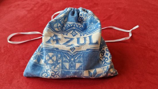 Azul board game review - author photo showing the tile bag, with the title Azul on it