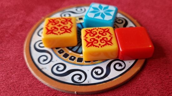 Azul board game review - author photo showing four coloured tiles on one of the supply dishes