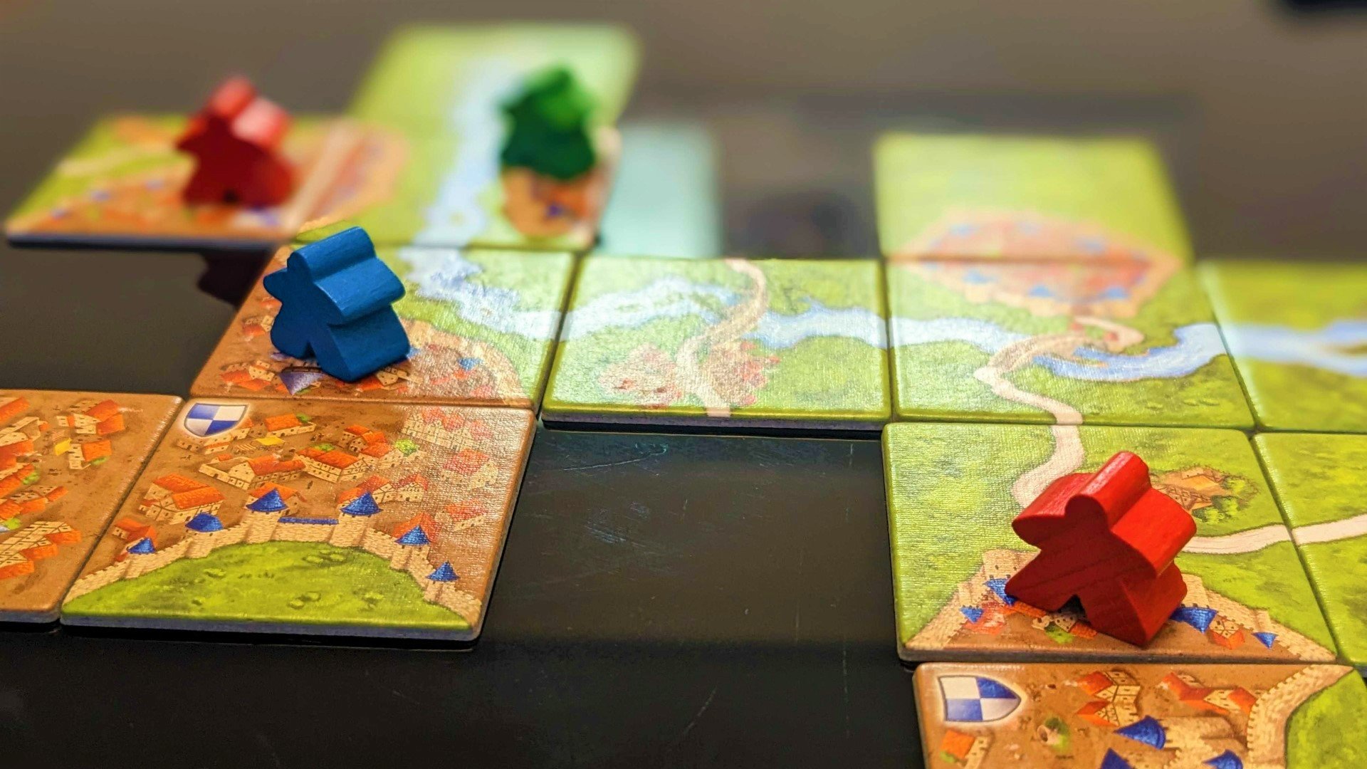 Carcassonne board game review - photo of meeples on tiles