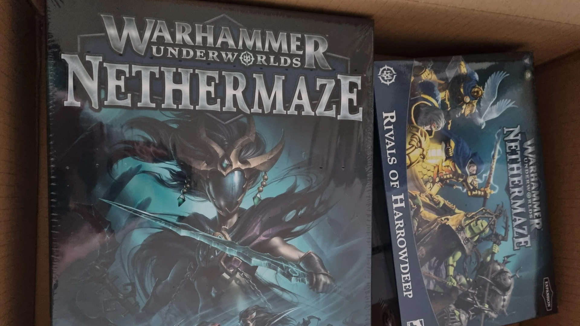 Warhammer 40k loot boxes landing - photograph of a pair of Warhammer Underworlds product boxes by redditor u/longshanksracey