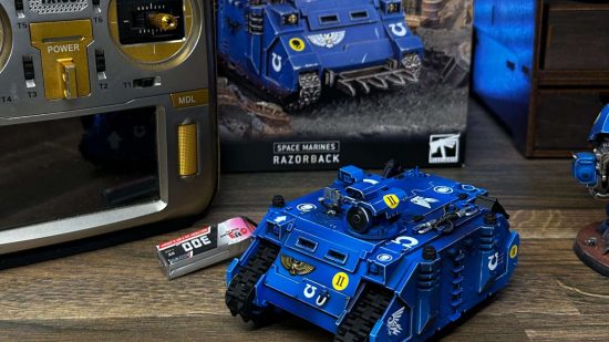 Warhammer 40k Space Marine tank remote control - photo of a converted Razorback by Brent Goudie beside a remote control and the product box