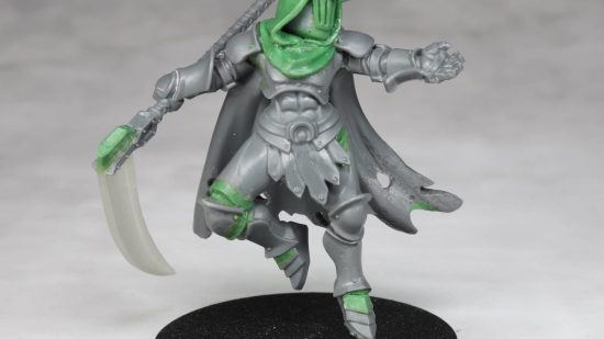 Warhammer Age of Sigmar Shovel Knight mini conversions - creator photo showing a work in progress stage of the specter knight mini, with grey plastic and green stuff