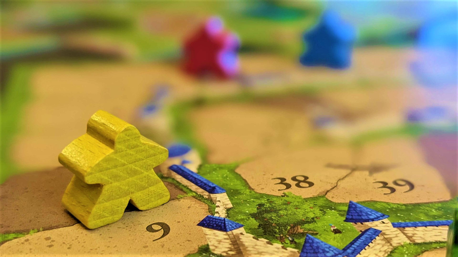 Meeples and scoring board from Carcassonne, one of the best gateway games