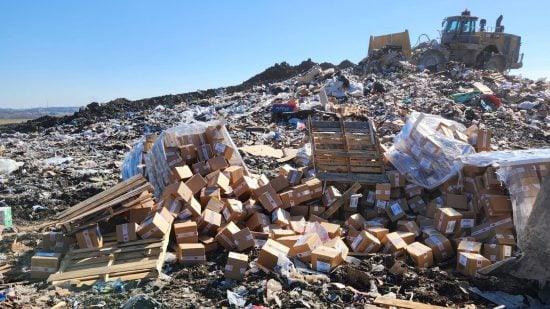 MTG cards landfill - pallets of cardboard boxes in a landfill