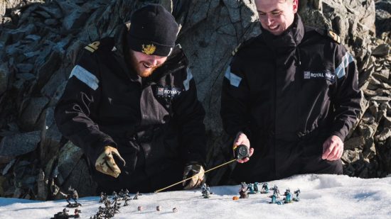 Warhammer 40k competitive player Jonny Talbot and friend Max Friswell, both in black royal Navy uniform, play a game of Warhammer 40k in the Antarctic