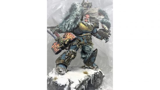Warhammer 40k Space Marine action figure converted into Logan Grimnar by Christopher Coffey - a huge, wild-haired, snarling man in imposing armour, wielding a massive axe, a fur cloak around his shoulders, posing atop a rock