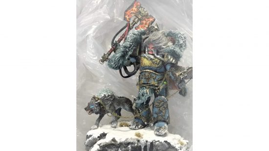 Warhammer 40k Space Marine action figure converted into Logan Grimnar by Christopher Coffey - a huge, wild-haired, snarling man in imposing armour, wielding a massive axe, a fur cloak around his shoulders, holding a wolf on a chain