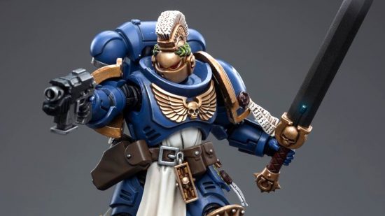 Warhammer 40k Space Marine Primaris Champion figure by JoyToy - a 1/18 scale action figure of a Blue Armoured space marine with a gold helmet, horeshair crest, power sword and bolt pistol, in a shooting pose