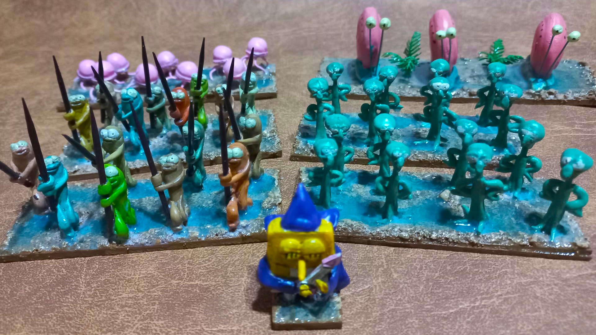 Sponge Bob Warhammer army - SpongeBob in a wizard hat playing a guitar, made from cold porcelain, leading an army of fish with pikes, squidwards, polyps, and Gary the snail