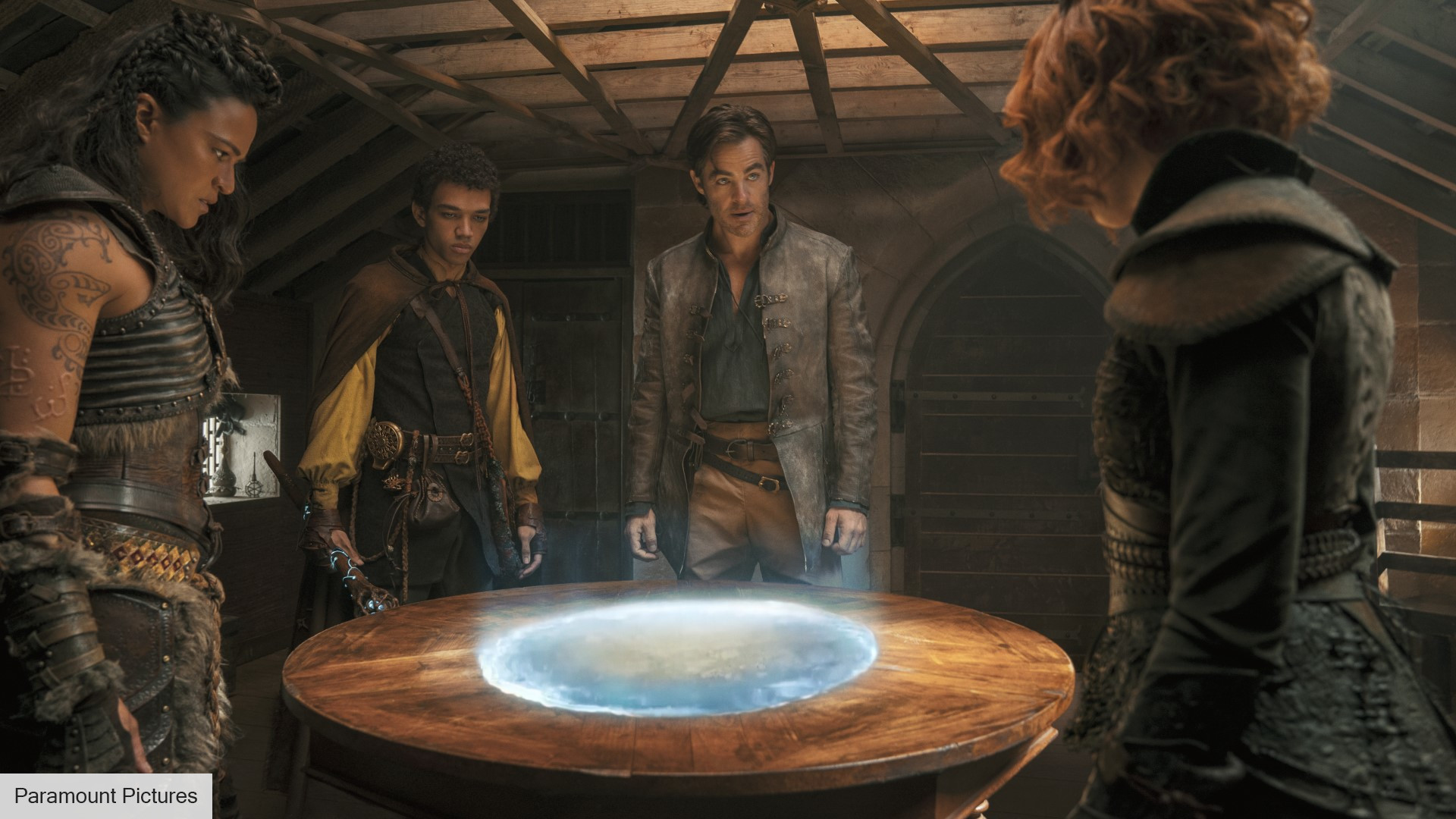 DnD Honor Among Thieves review - Paramount image of Holga, Simon, Edgin, and Doric looking at a magical portal