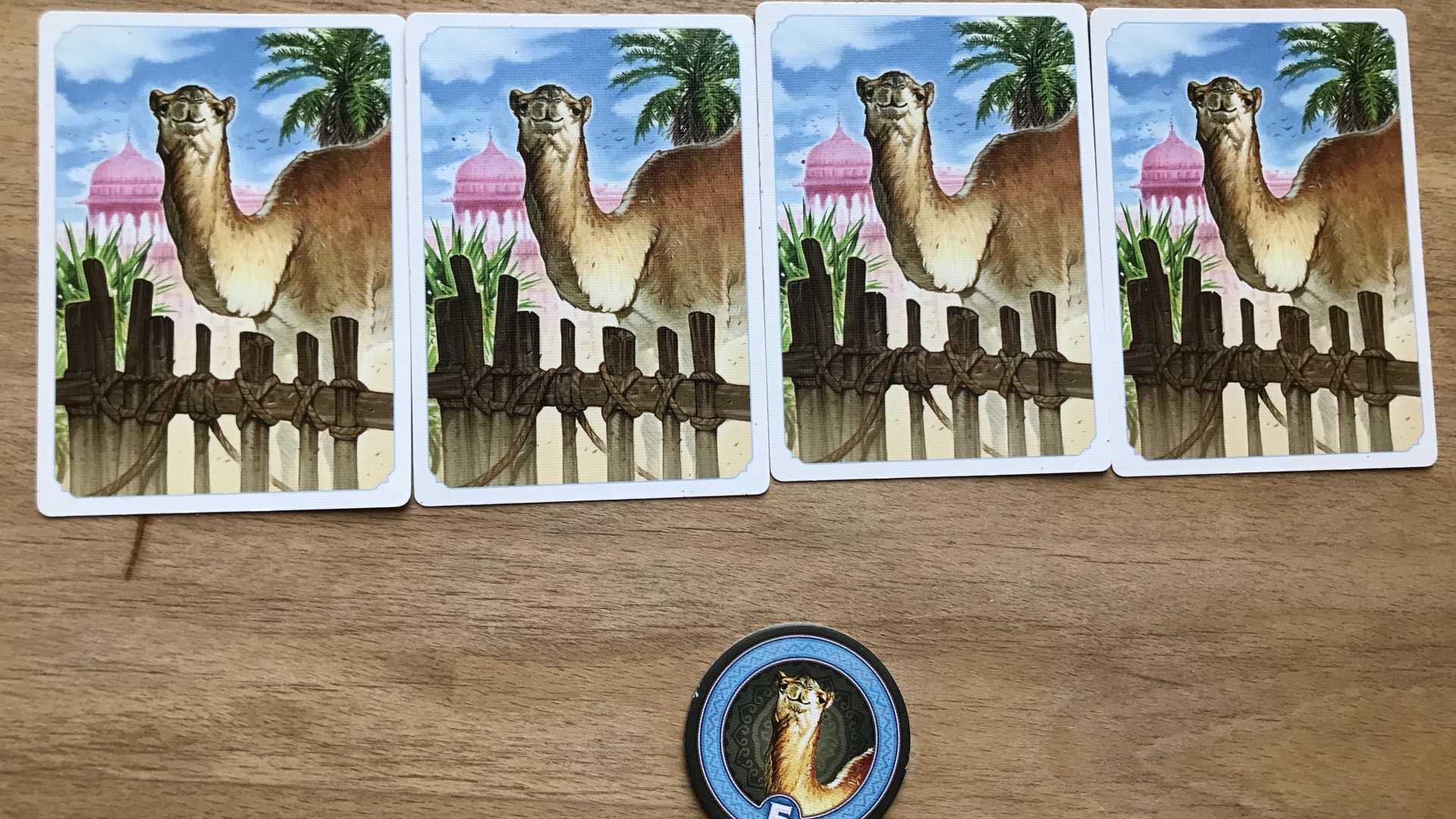 Jaipur board game - a row of four camels and a camel token