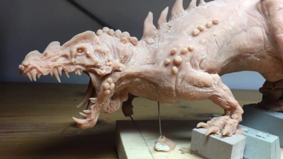 Total War Warhammer 3 Dread Saurian - a pink Sculpey mockup of a crocodilian monster, closeup on the detail of head and forelimbs