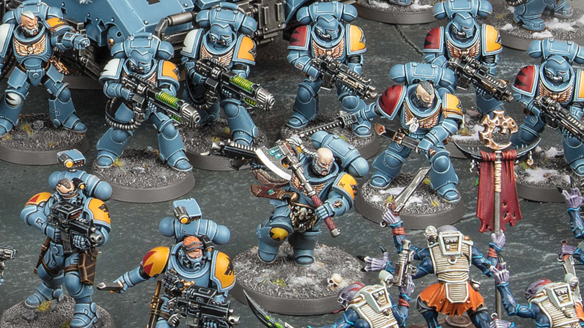 Warhammer 40k Space Wolves - a force of Primaris Space Wolves, power-armoured warriors in grey armour, wielding a mixture of axes, boltguns, and plasma weapons