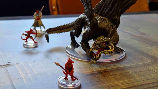 DnD Onslaught starter set review - a black dragon roars at kobolds, models by WizKids