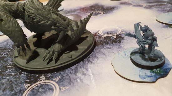 Monster Hunter World Iceborne board game preview - a Barioth faces off against a dual blade hunter