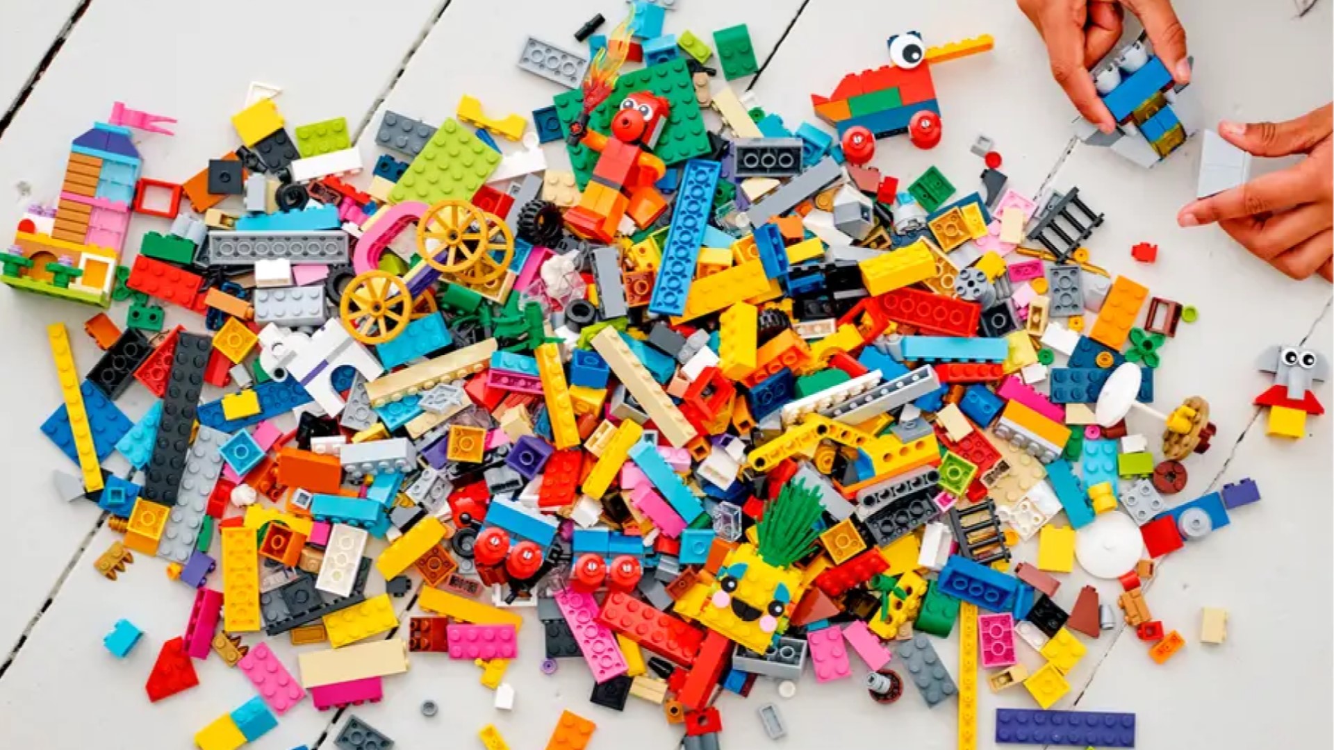Best Lego sets - a large assorted pile of lego bricks, with a few small builds strewn among them.