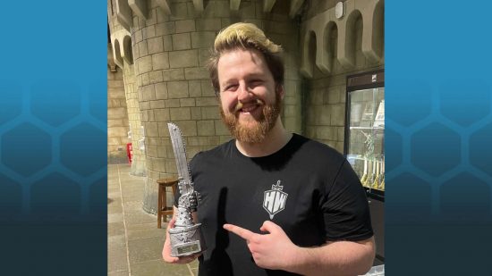 Warhammer YouTuber Mikey Herbert from Hellstorm Wargaming holding a silver chainsword at Warhammer World for a Warhammer 40k tournament position 