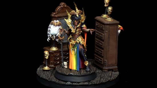 Age of Sigmar vampire limited edition model Anasta Malkorion, painted as a drag queen, with black pompadour wig, amazing sequined high collar, and rainbow tabard, posed in her boudoir