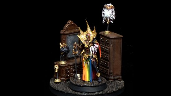 Age of Sigmar vampire limited edition model Anasta Malkorion, painted as a drag queen, with bald head, amazing sequined high collar, and rainbow tabard, posed in her boudoir